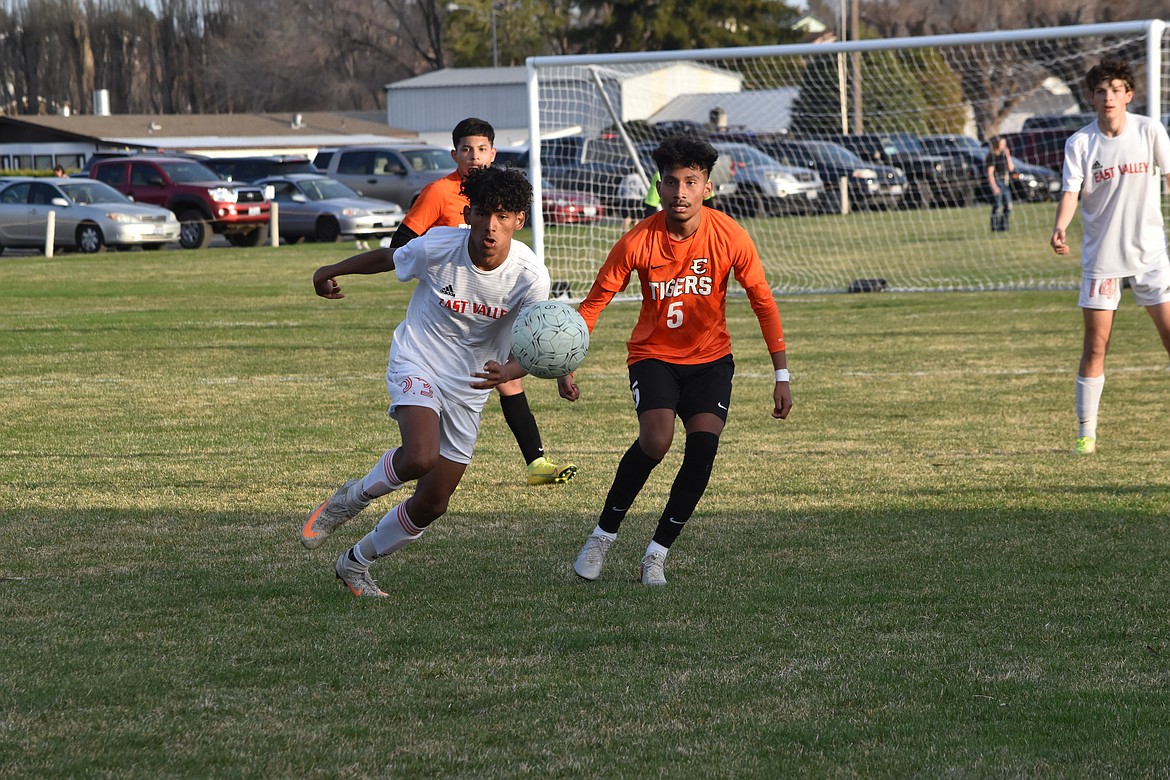 An East Valley player and Ephrata High School junior Diego Garcia (5) eye the ball as it is passed during the matchup at Ephrata High School on March 29.