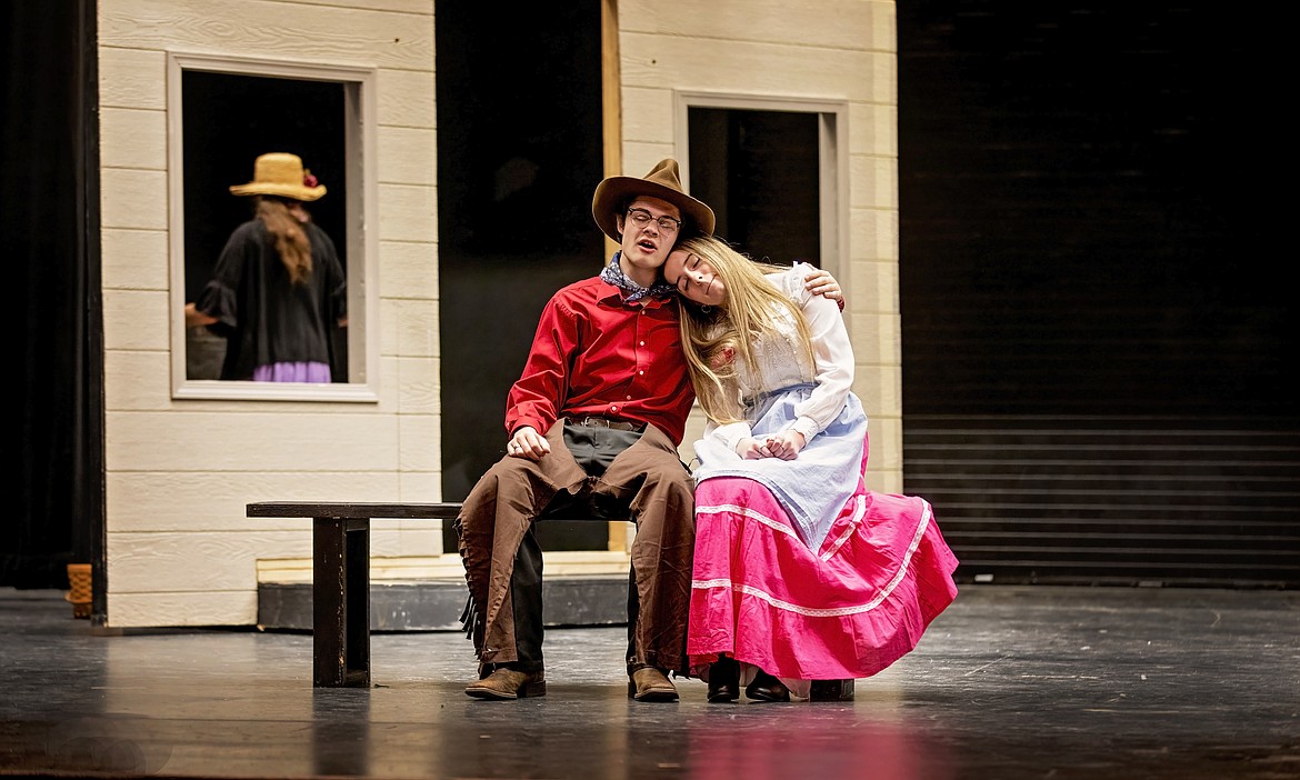 Curly (Ryan Horn, left) wants to ask Laurey (Summer Bowen, right) to the box social in the Moses Lake High School Drama production of “Oklahoma!”