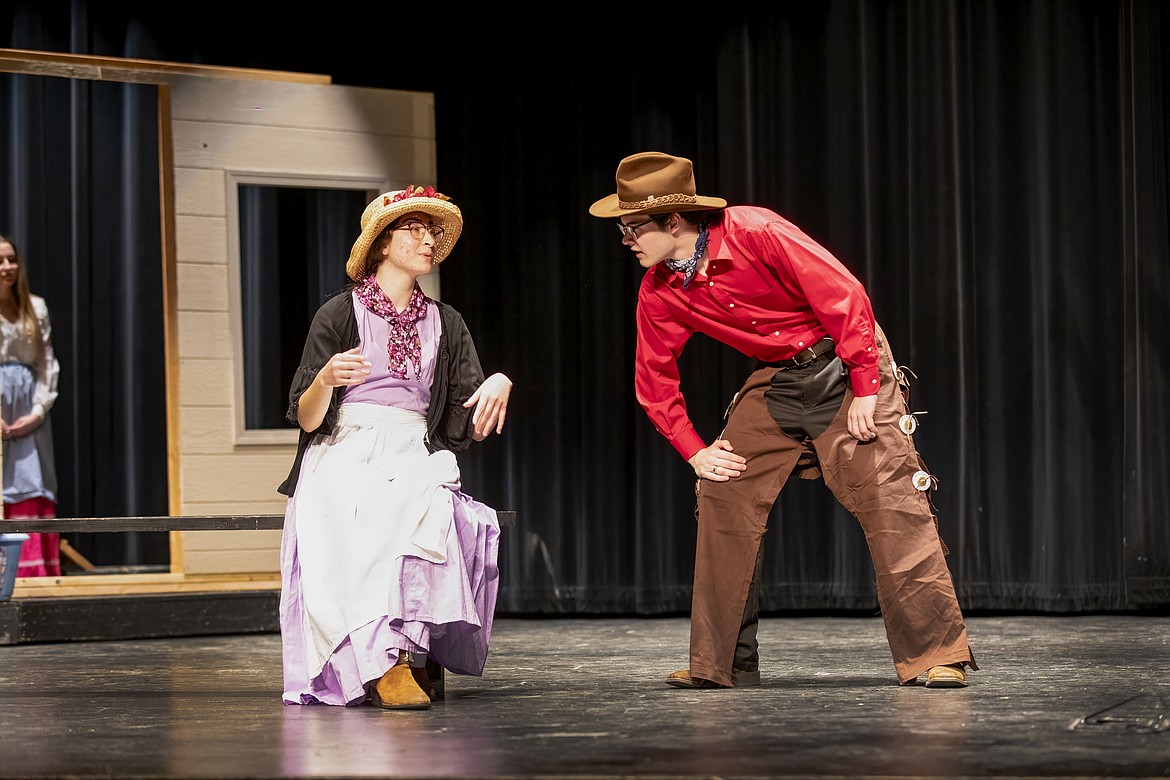 Curly (Ryan Hone, right) seeks relationship advice from Aunt Eller (Isabella Erickson, left) in the Moses Lake High School Drama production of “Oklahoma!” The young actors weren’t familiar with the play initially, but warmed up to it quickly, they said.