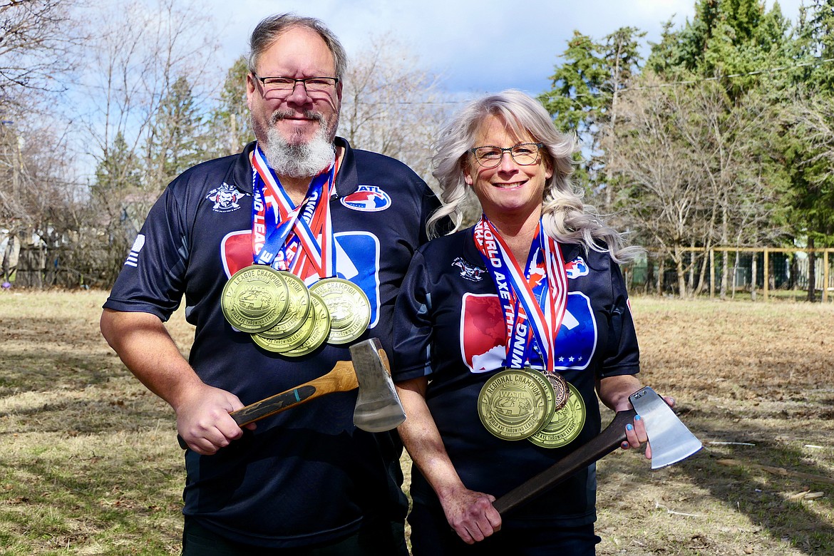 Lindy Smith and her husband Ken display medals the won at ax-throwing competitions. (Heidi Desch/Daily Inter Lake)