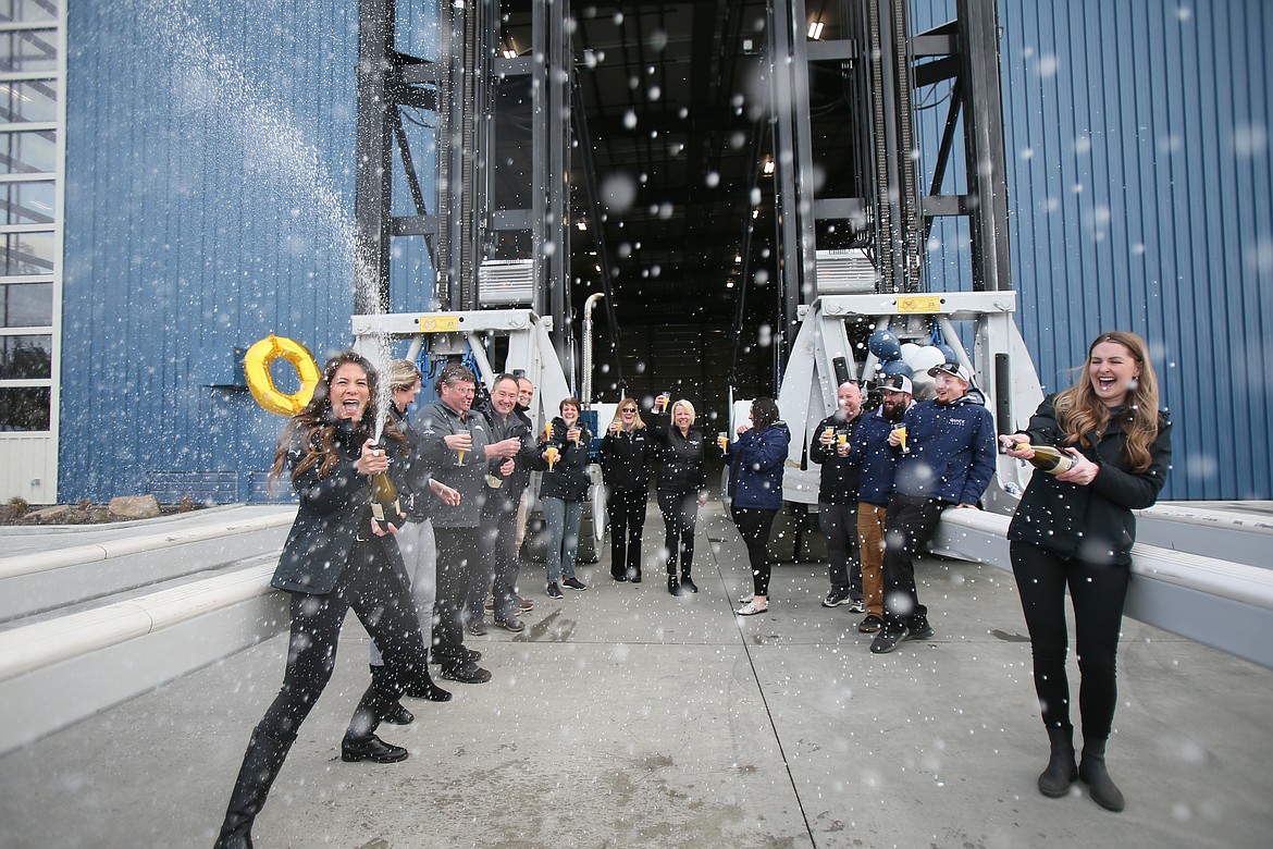 Hagadone Marine team members enjoy a bubbly celebration for the official opening of the Vertical Quick Launch Dry Stack facility.