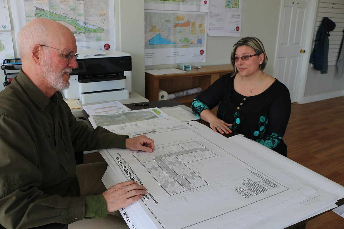 Bonner Community Housing Agency Executive Director Rob Hart, left, and project manager Chrystle Horvath, right, look at a site plan in April for the Culver's Crossing planned unit development.