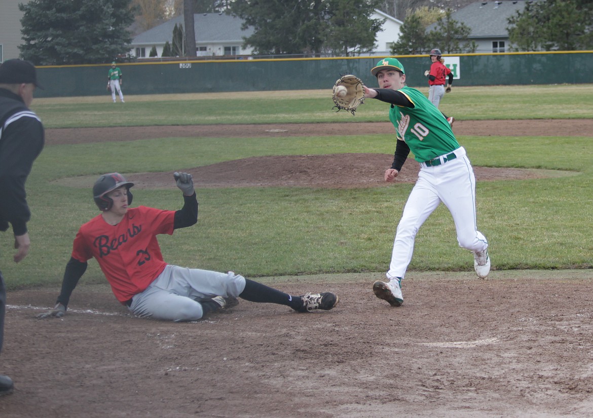 MARK NELKE/Press
Lakeland pitcher Tim Sheppard reaches for the throw from the catcher as Cody Isakson of Moscow slides home safely during the first game of an Inland Empire League baseball doubleheader Saturday at Gorton Field in Rathdrum.