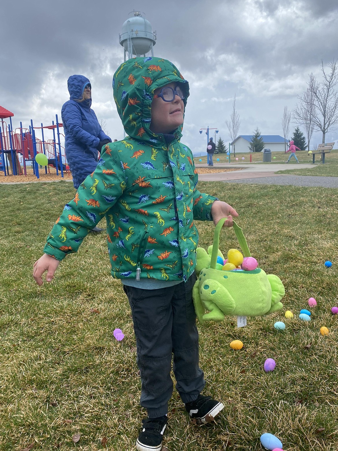 Six-year-old Ronin Kale holds his full-to-the-brim basket of Easter eggs, Saturday at the Village Bakery inclusive egg hunt, held at Majestic Park in Rathdrum.