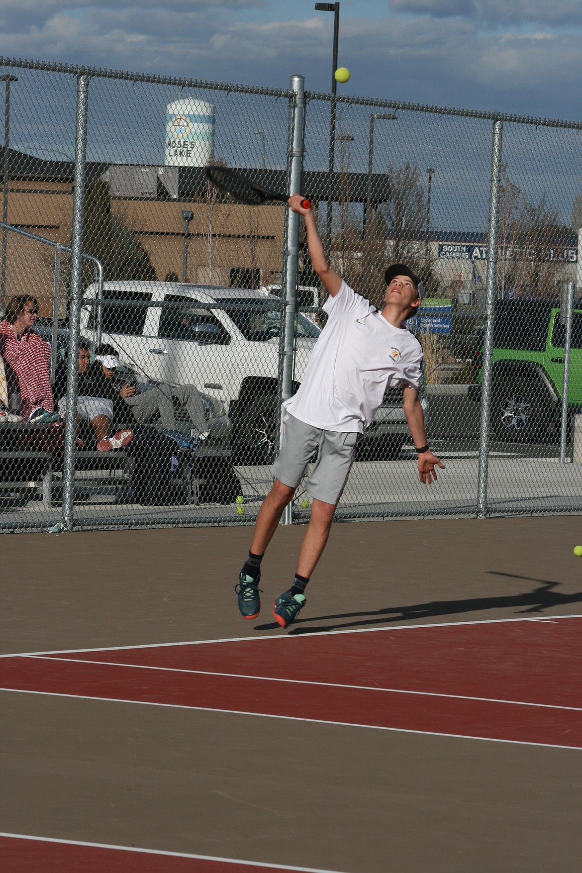 Roman Jenks leans into the serve during the match between Moses Lake and Eastmont Thursday.