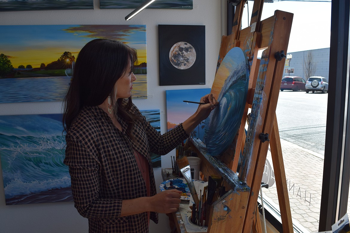 Landscape artist Hannah Fountain paints a seascape in her space at the Downtown Moses Lake Association’s new Obra Project business incubator. Fountain painted a large mural, a view of the Columbia River looking west from Quincy, inside the space at 205 S. Division St.