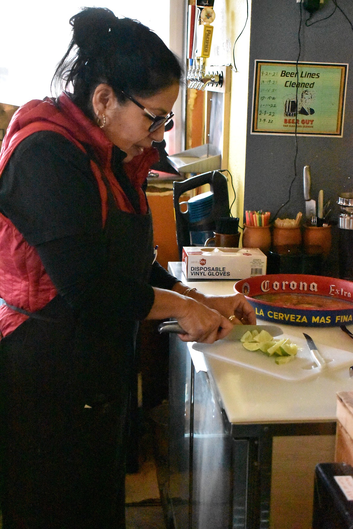 Emerita Villafana, owner and operator of Mi Cocinita Mexican Grill and Cantina in Soap Lake, cuts limes for an order.