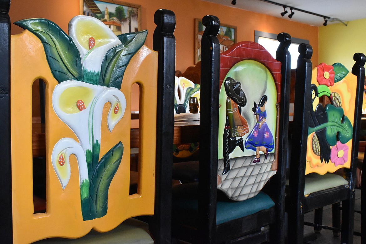 The chairs in the dining area at Mi Cocinita Grill and Cantina have unique, handmade pictures carved and painted into them.