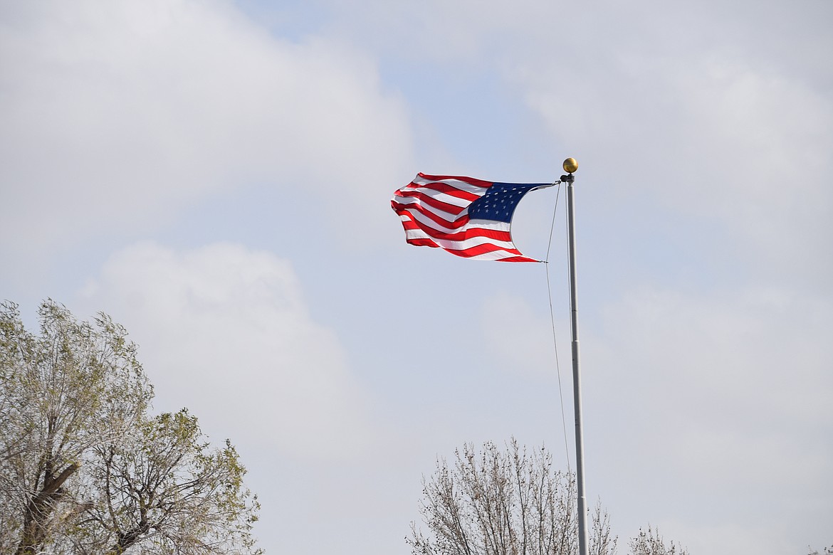 A U.S. flag above Peninsula Elementary School flutters in gusts of over 40 miles per hour on Monday as a cold front moving over Eastern Washington brought powerful winds to the area. Area power management officials said they were prepared in the event of a power outage caused by the high winds.