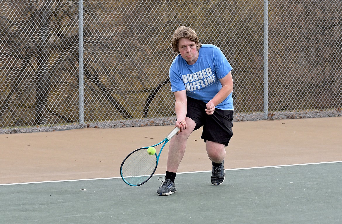 Bulldog Neil Bernat catches up with the ball during a boys tennis practice last week. (Whitney England/Whitefish Pilot)