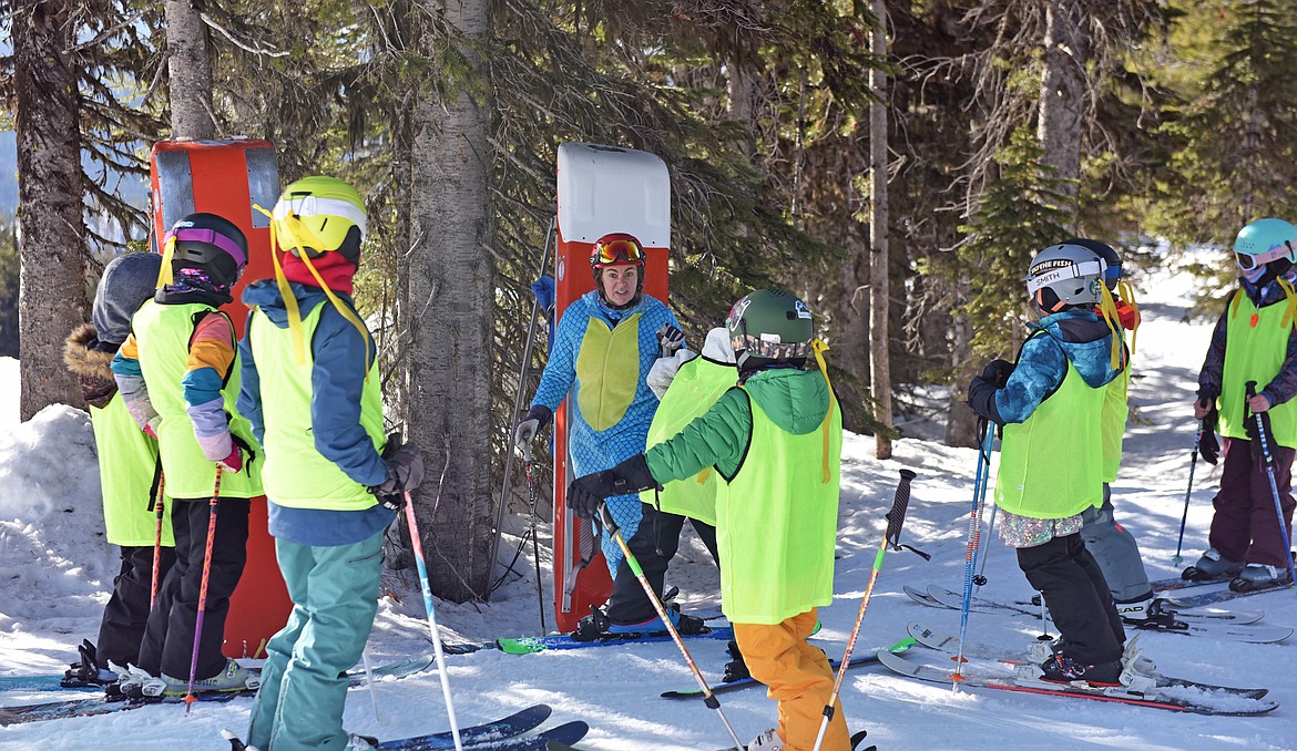 Patroller Kelsey guides a group of SheJumps Junior Ski Patrol Day participants through their morning duty. (Julie Engler/Whitefish Pilot)