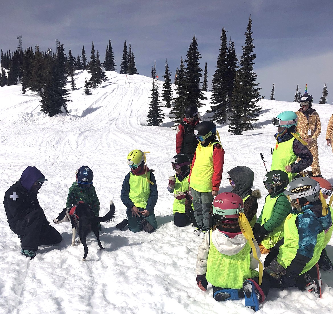 SheJumps Junior Ski Patrol Day participants meet Cleo, the avalanche dog at Whitefish Mountain Resort. (Julie Engler/Whitefish Pilot)