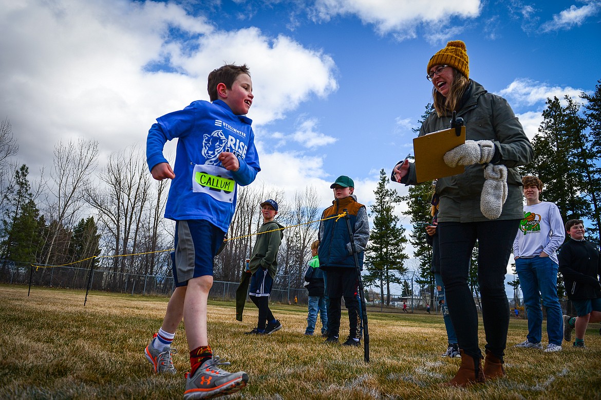 A runner crosses the finish line at the Evergreen Schools' cross country meet on Tuesday, April 5. (Casey Kreider/Daily Inter Lake)
