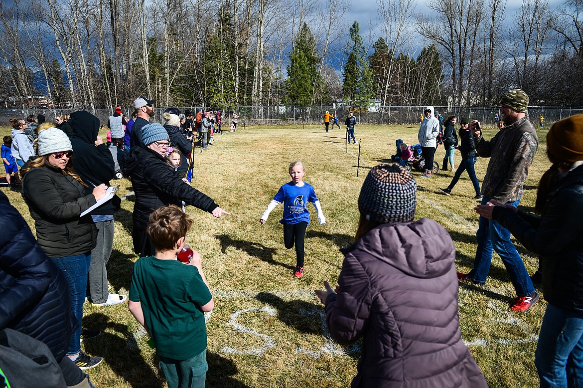 A runner reaches the finish line at the Evergreen Schools' cross country meet on Tuesday, April 5. (Casey Kreider/Daily Inter Lake)