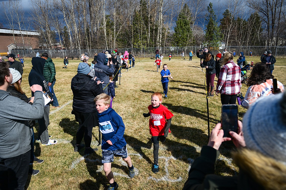 Runners reach the finish line at the Evergreen Schools' cross country meet on Tuesday, April 5. (Casey Kreider/Daily Inter Lake)