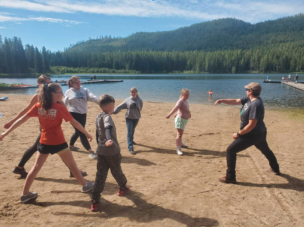 Members of the 4-H club of the year, the Round Mountain Ryders, enjoy activities on the beach with nature hike leader Angie Carhart (right). 4-H members, clockwise from center front: Reed Dickson, Maddy Devlin, Cara Dickson, Ally Shell, Alycia Cameron and Molly Swanson.