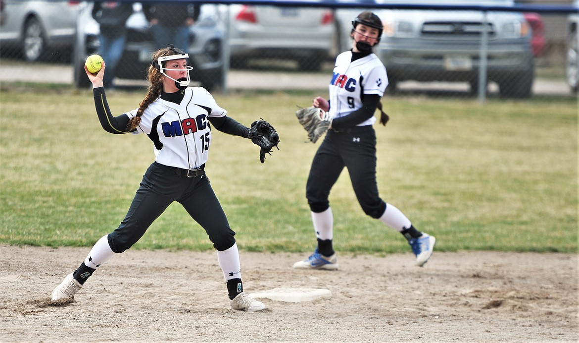 Shortstop Lettie Umphrey throws to first in front of teammate Cassidy Orr during the second game against Anaconda. (Scot Heisel/Lake County Leader)