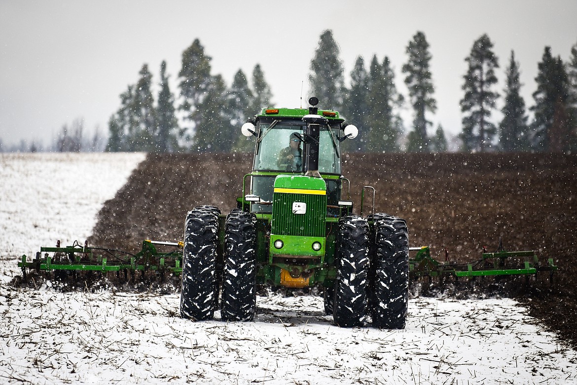 A farmer plows a snow-covered field along Jaquette Road on Saturday, April 2. (Casey Kreider/Daily Inter Lake)