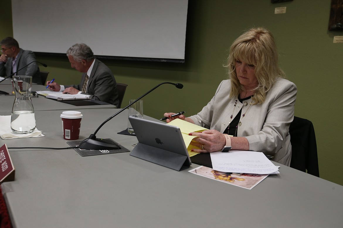 North Idaho College Trustee Christie Wood reviews her notes on the 10 candidates interviewed for the vacant Zone 5 seat during Wednesday’s special meeting. KAYE THORNBRUGH/Press