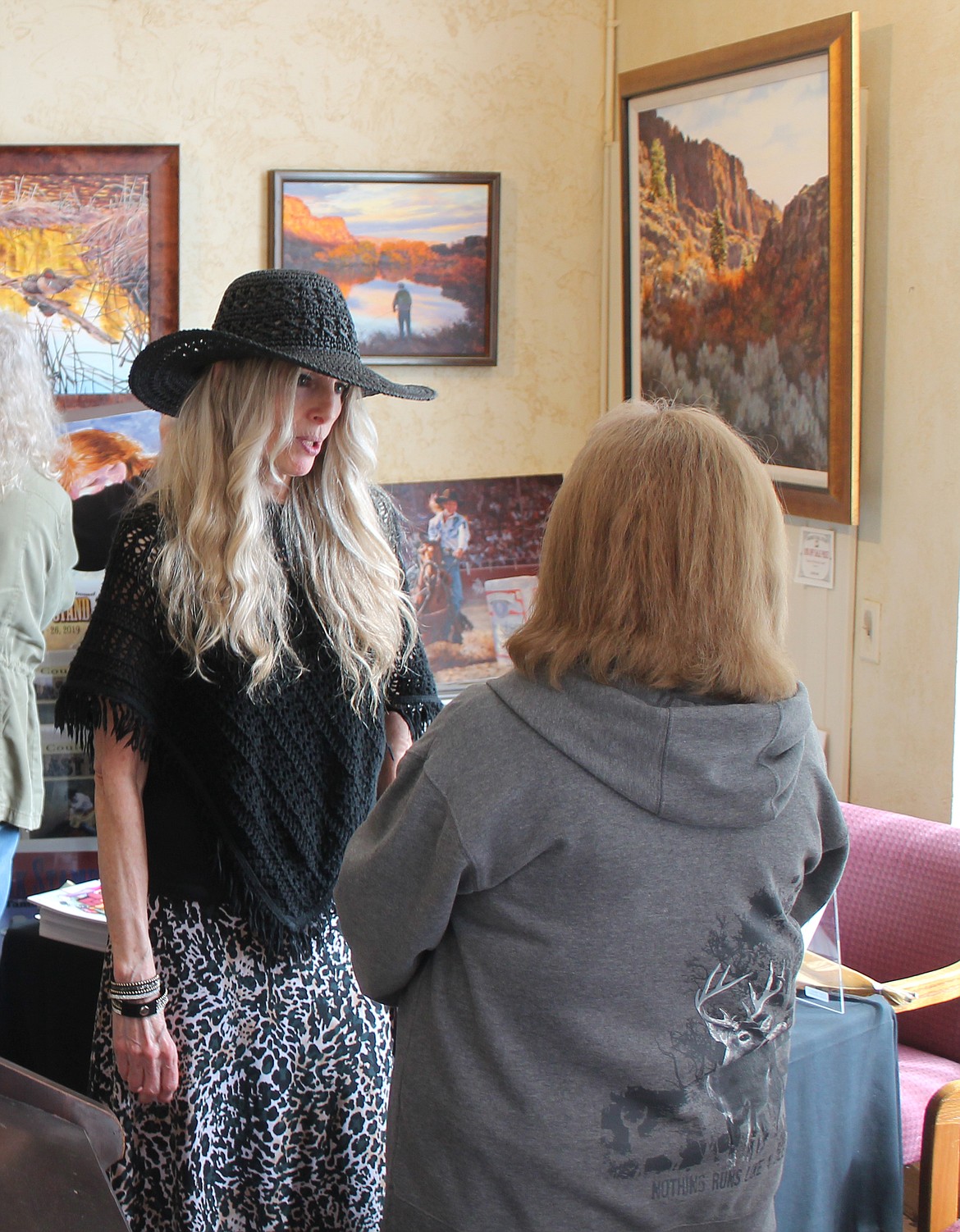 Author Lyn D. Nielsen, left, chats with Nancy Winterooth at Cariboo Trail Studio in Coulee City April 1. Nielsen was signing books as part of the April Fools Art Walk.