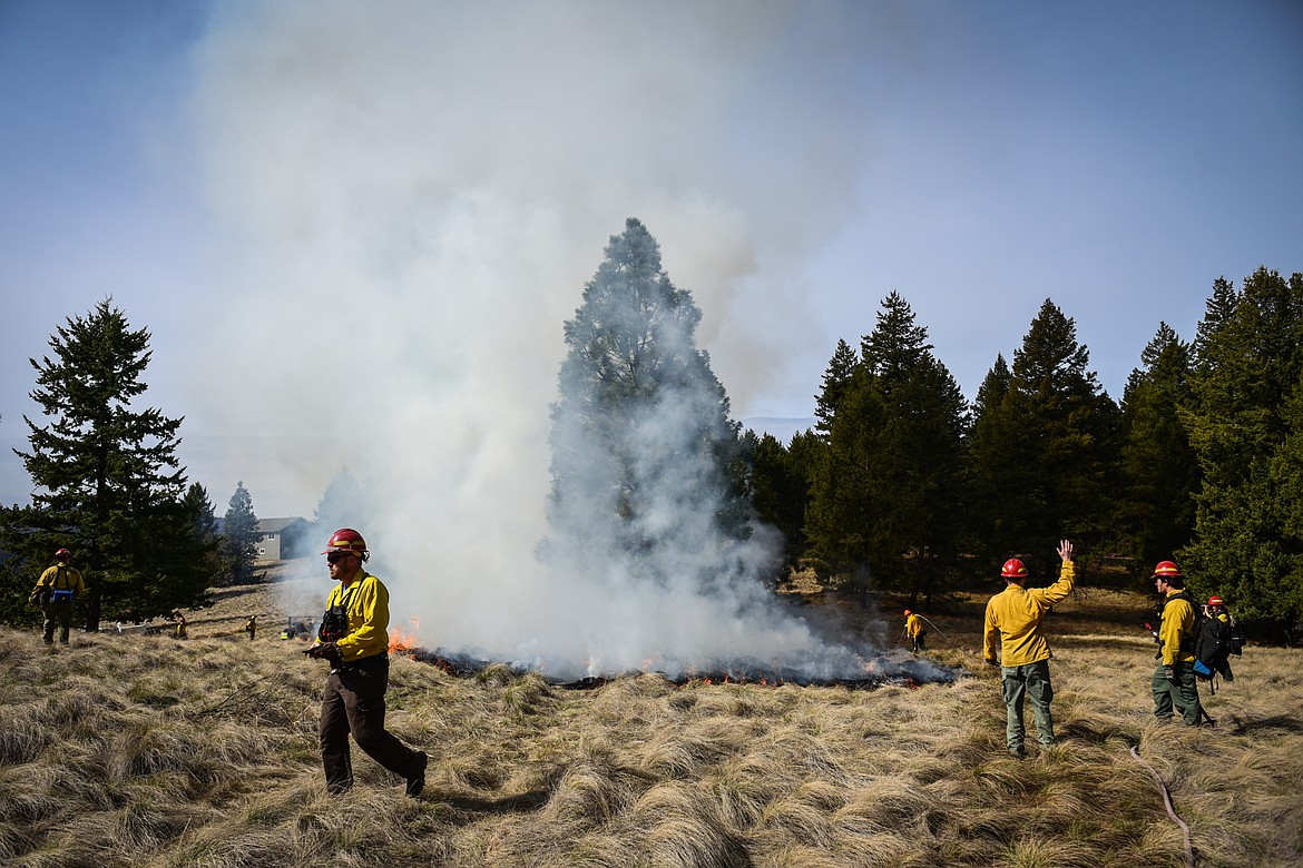 Fire crews from the Montana Department of Natural Resources & Conservation conduct a prescribed burn at Lone Pine State Park in Kalispell on Thursday, April 7. Held in conjunction with Montana Fish, Wildlife & Parks, the prescribed fire is aimed at benefiting the park's grassland habitat, including native plants and the wildlife species that frequent the area.(Casey Kreider/Daily Inter Lake)