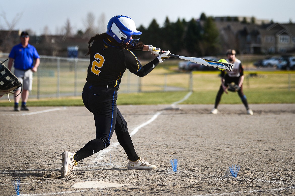 Libby's Paislee MacDonald (2) connects on a single in the first inning against Flathead at Kidsports Complex on Thursday, April 7. (Casey Kreider/Daily Inter Lake)