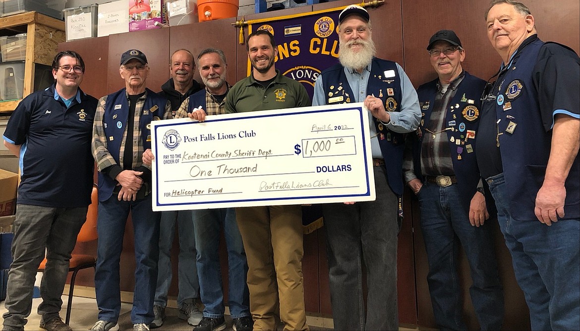 The Post Falls Lions Club donated $1,000 toward the Kootenai County Sheriff's Department purchase of a helicopter for Idaho’s first Air Support Unit. From left: Lions Joel Nelson, Rick Steele, Ted Macaulay, Paul Wagner, KCSD Lt. Mark Ellis, Lyndon Harriman, Bert Thoreson and Richard Smith.