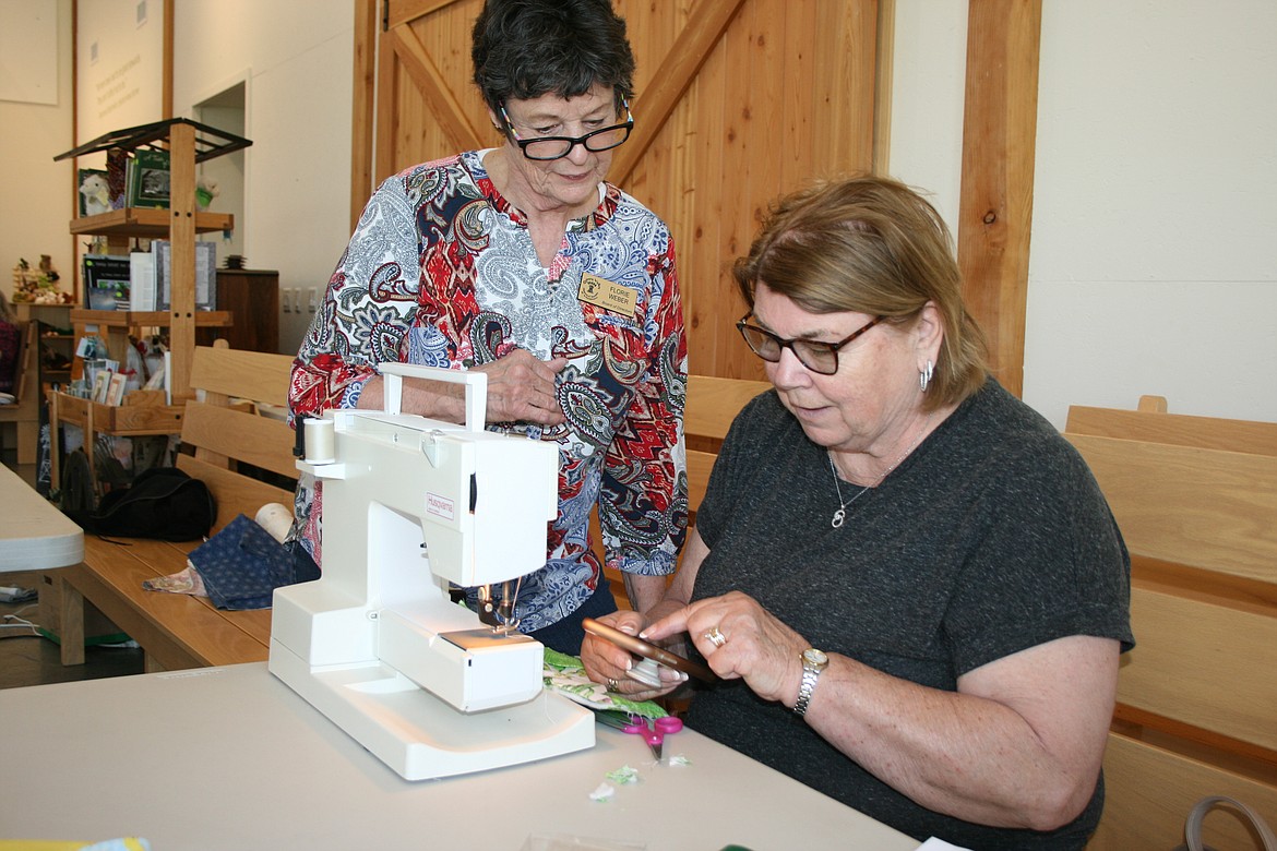 Florie Weber (left) and Marylou Krautscheid (right) check out some of the quilt projects they’ve made during Community Sew Day. The Quincy Valley Historical Society sponsored the April 4 event as a way to bring people together.