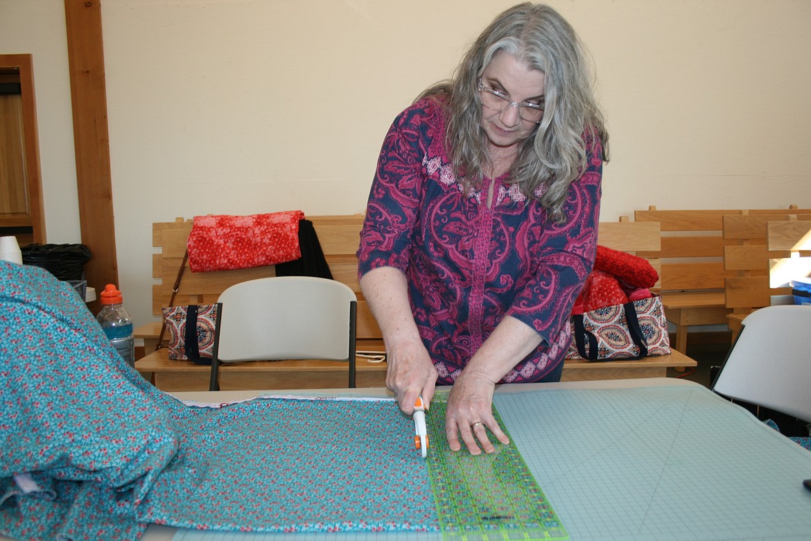 Ann Downs cuts fabric for a charitable project at Community Sew Day April 4, sponsored by the Quincy Valley Historical Society and Museum.