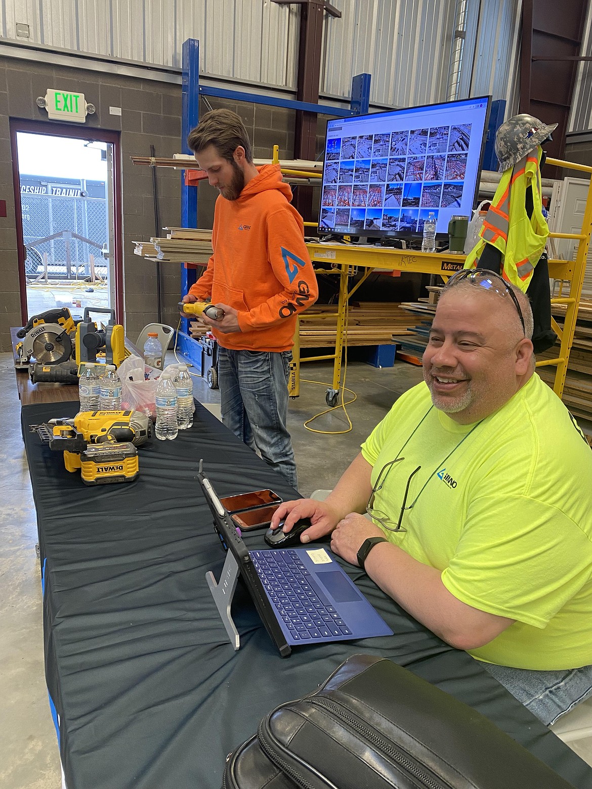 From left: Ginno Construction employees Robert Torgerson and Greg Rodriguez at the Post Falls Chamber Hard Hats, Hammers and Hot Dogs event Friday at Kootenai Technical Education Center.