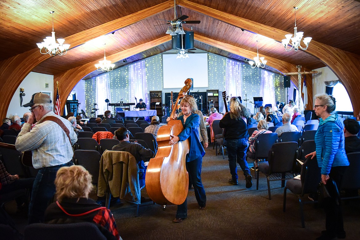 Musicians carry their instruments at the 12th annual Glacier Fiddle Festival at Cornerstone Community Church in Kalispell on Saturday, April 9. (Casey Kreider/Daily Inter Lake)