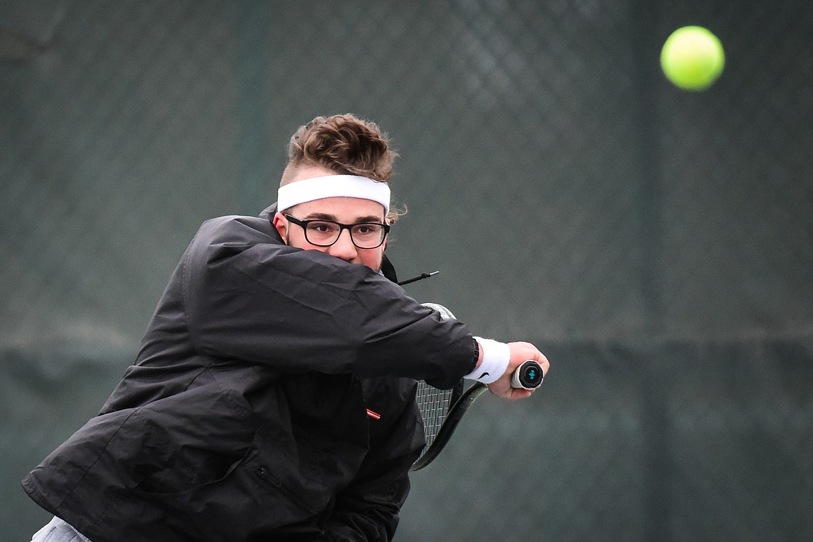 Flathead's Quaid Ring hits a return against Missoula Big Sky's Jacob Kientz at Flathead Valley Community College on Saturday, April 9. (Casey Kreider/Daily Inter Lake)