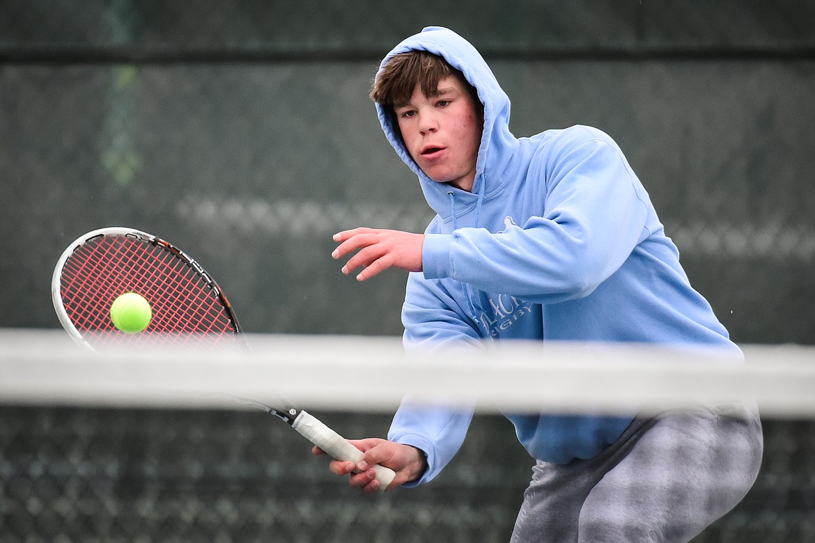 Flathead's Kutuk White hits a return against Missoula Big Sky's Ayden Porch at Flathead Valley Community College on Saturday, April 9. (Casey Kreider/Daily Inter Lake)