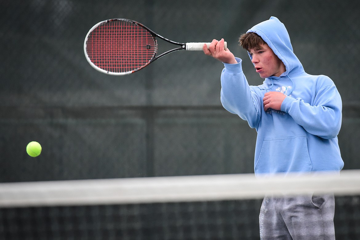 Flathead's Kutuk White hits a return against Missoula Big Sky's Ayden Porch at Flathead Valley Community College on Saturday, April 9. (Casey Kreider/Daily Inter Lake)