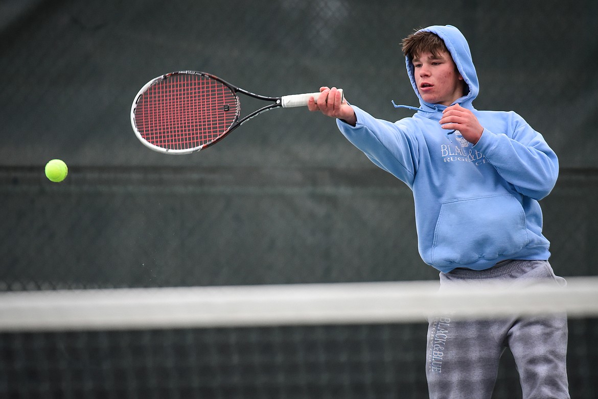 Flathead's Kutuk White hits a return against Missoula Big Sky's Ayden Porch at Flathead Valley Community College on Saturday, April 9. (Casey Kreider/Daily Inter Lake)