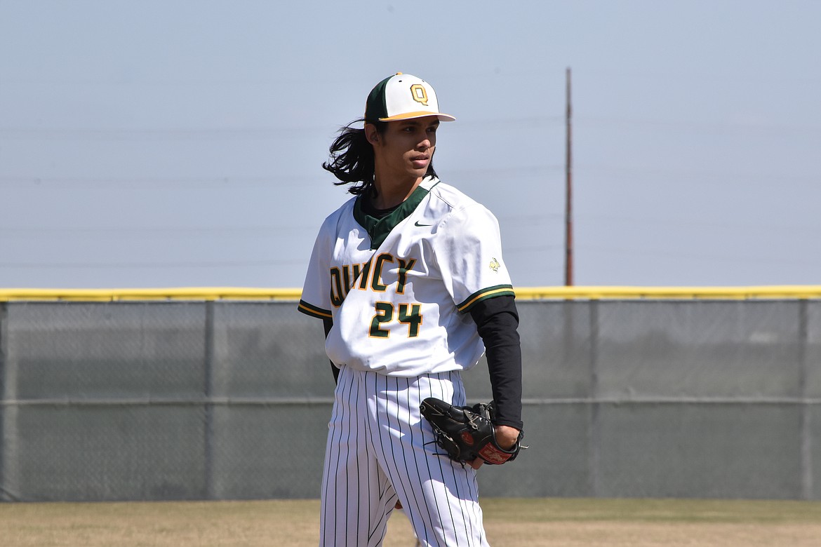 Quincy High School senior Benji Medina, Jr. (24), looks toward home plate just before winding up for the pitch on April 8 against Montesano.