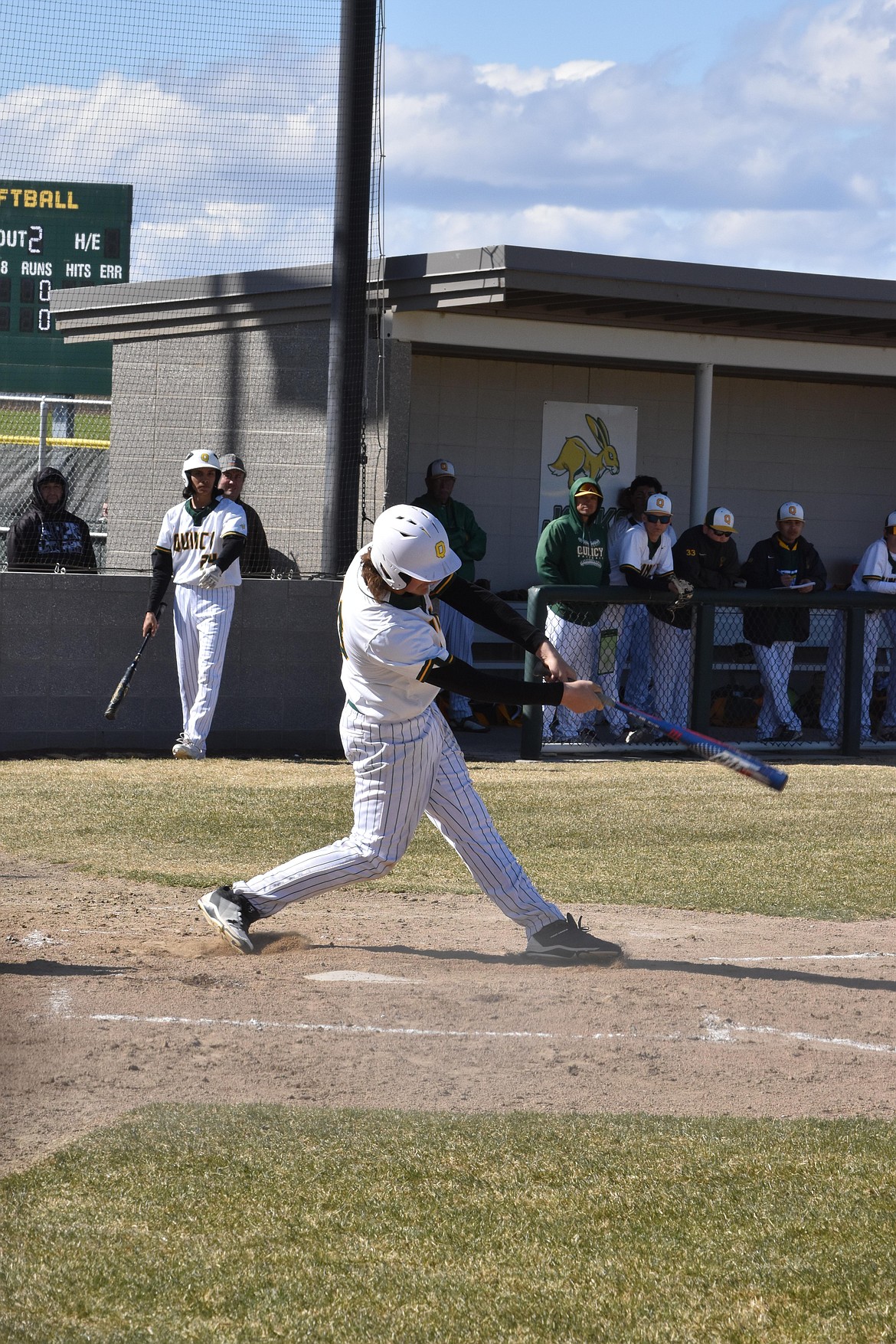 Quincy High School junior Caden Cameron (20) swings at a pitch by Montesano on April 8. Quincy lost the home game 9-0.