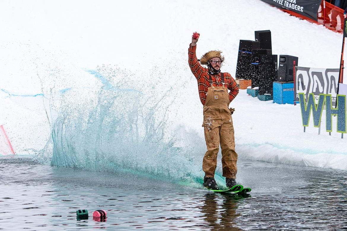 The skier Johnny Appleseed holds up a shinny red apple. (JP Edge photo)