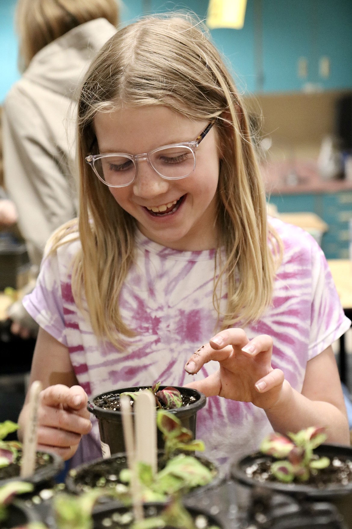 Hayden Meadows Elementary School third grader Alexa Jensen works to prepare plants for the school greenhouse on Friday. HANNAH NEFF/Press