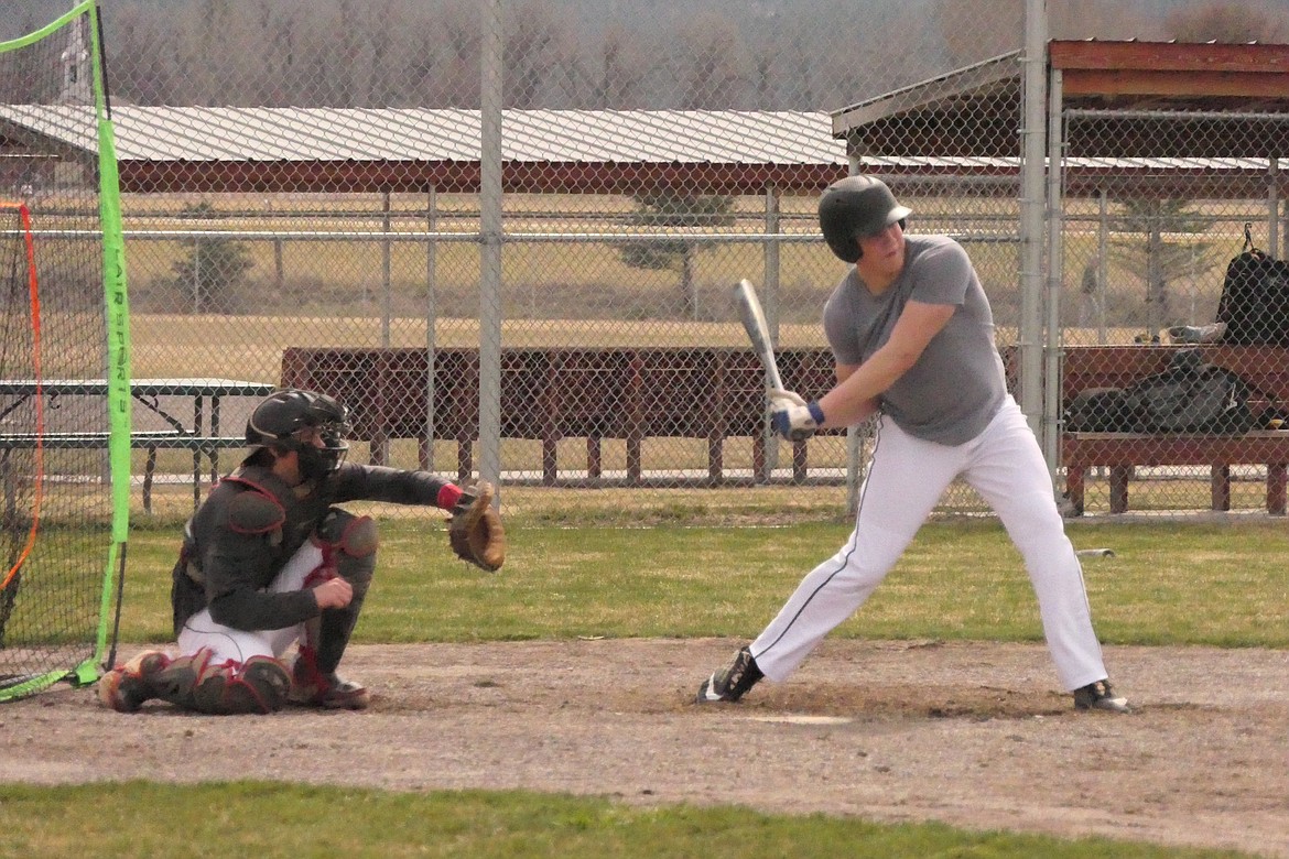 Hot Springs player Garth Parker eyes an incoming pitch as catch Orion Plakke of Superior readies to catch the ball. (Chuck Bandel/VP-MI)