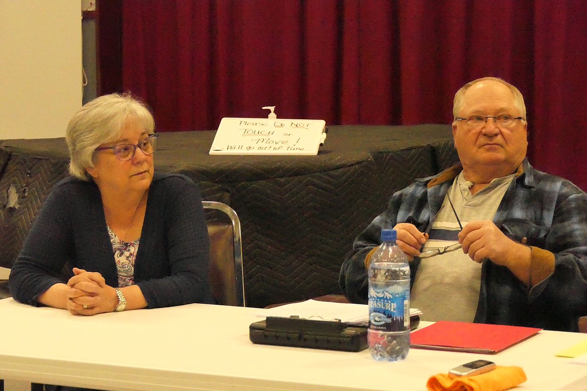 Ousted board member Janis Barber listen to the proceedings that officially removed her from the Paradise Sewer Board while Board member Terry Caldwell prepares to vote on the matter. (Chuck Bandel/VP-MI)