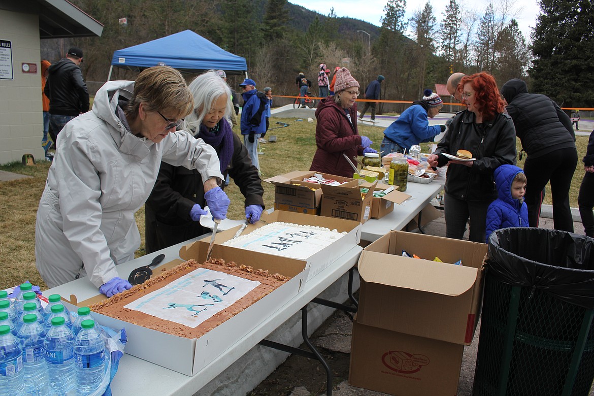 Sheelia Miller, left, and Shirley Iwata serve cake at the Grand Opening of the Superior Skatepark to a crowd who also enjoyed hamburgers, chips and beverages on a cold and windy Saturday morning. Dedication announcements were given by Superior Mayor, Roni Phillips, Brenda Schneider, Town of Superior and Jeff Ament of Pearl Jam. The park is open and free for rad skating.