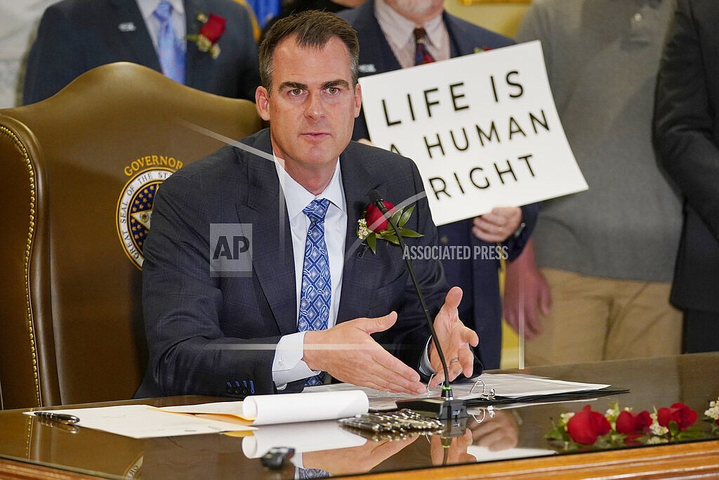 Oklahoma Gov. Kevin Stitt speaks after signing into law a bill making it a felony to perform an abortion, punishable by up to 10 years in prison, Tuesday, April 12, 2022, in Oklahoma City. (AP Photo/Sue Ogrocki)