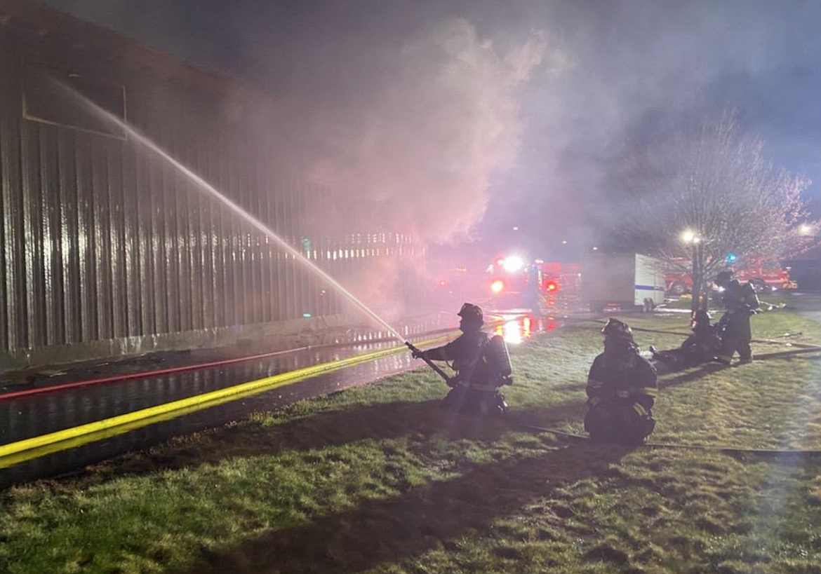 Firefighters spray a commercial building in that caught fire Tuesday evening in Hayden.