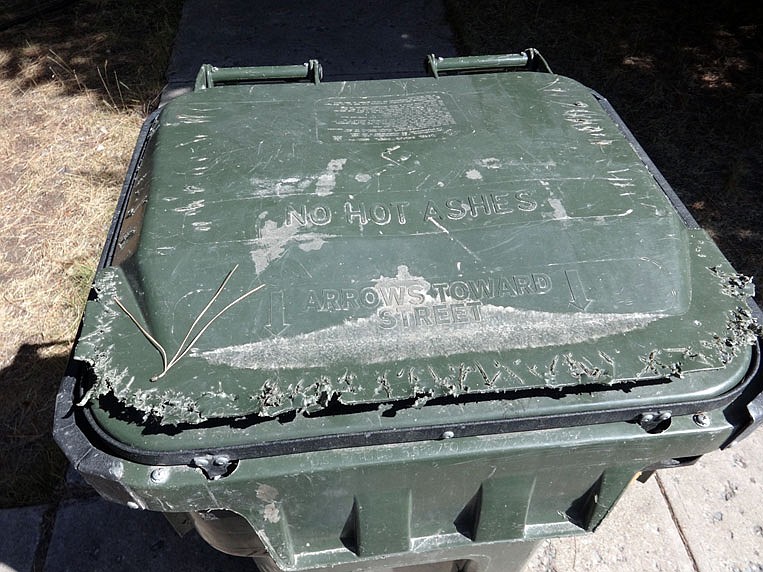 A trash can lid shows markings of where a bear tried to open it. (photo provided)