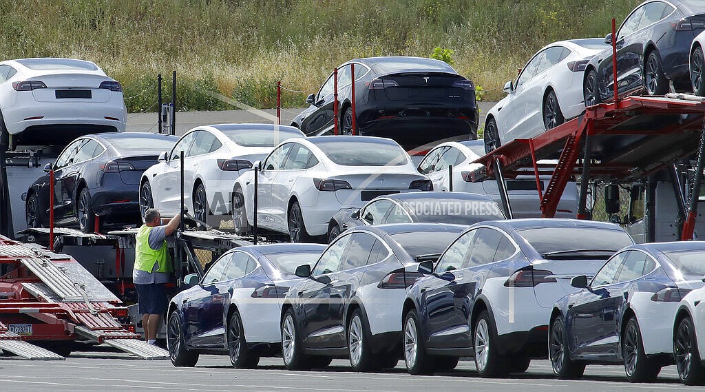 In this May 13, 2020, file photo, Tesla cars are loaded onto carriers at the Tesla electric car plant in Fremont, Calif. California wants electric vehicle sales to triple in the next four years to 35% of all new car purchases. Regulations passed Tuesday, April 12, 2022 by the California Air Resources Board set a roadmap for the state to achieve California Gov. Gavin Newsom's ambitious goal of phasing out the sale of new gas powered cars. The draft must go through a months-long state regulatory process and get approval from the U.S. EPA. (AP Photo/Ben Margot, File)