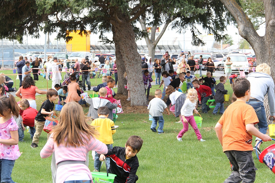 Hundreds of children scramble for Easter eggs at McCosh Park in Moses Lake for a previous Lions Club Easter egg hunt. This year's event takes place at noon on Saturday.