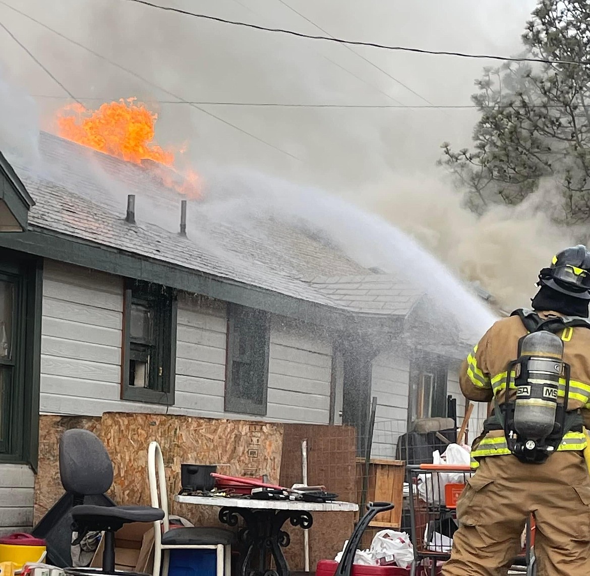 A firefighter battles a blaze which broke out in a small apartment building around 7 a.m. Wednesday at the corner of North Grape Drive and West Luta Street. It took firefighters from the Moses Lake Fire Department and Grant County Fire District 5 over three hours to extinguish the blaze, according to MLFD Chief Brett Bastian.