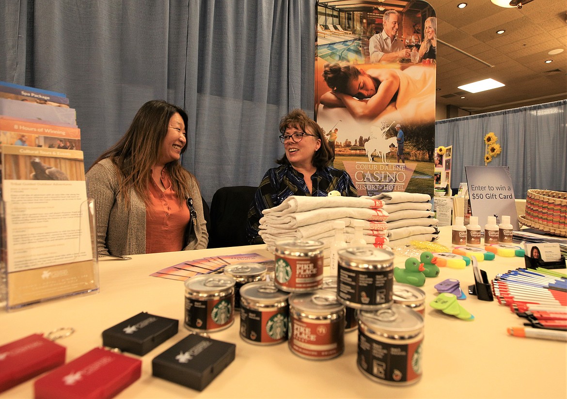 Allison Reiber, left, and Michelle Barnett with The Coeur d’Alene Casino Resort enjoy the 
business fair Wednesday at The Coeur d'Alene Resort.