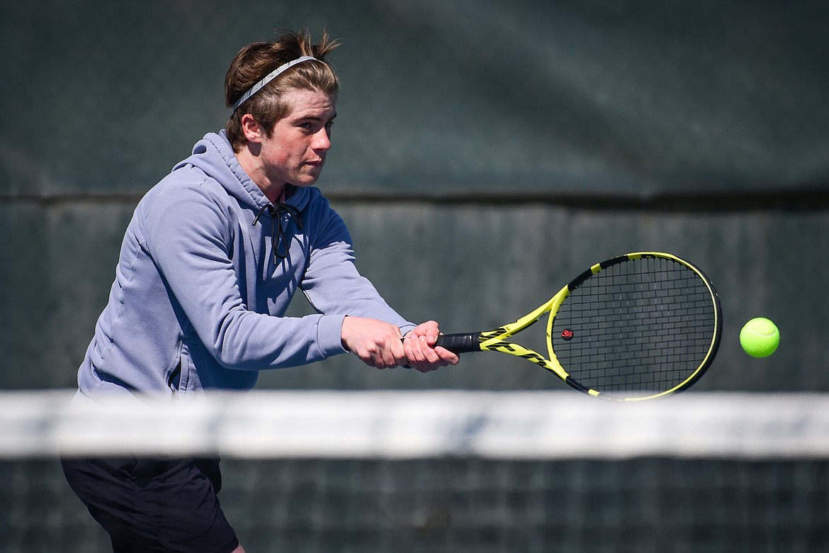 Glacier's Harrison Sanders hits a return against Flathead's Quaid Ring at Flathead Valley Community College on Thursday, April 14. (Casey Kreider/Daily Inter Lake)